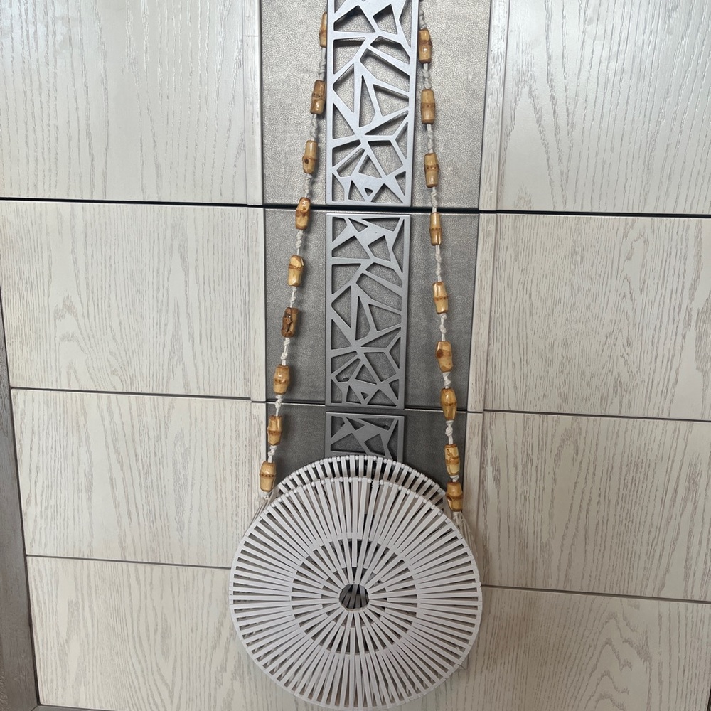 White handmade circular beach handbag with beaded strap